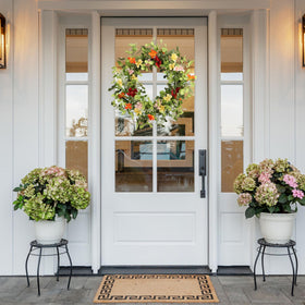 Pudate gift-ready spring wreath displayed as a thoughtful housewarming present.
