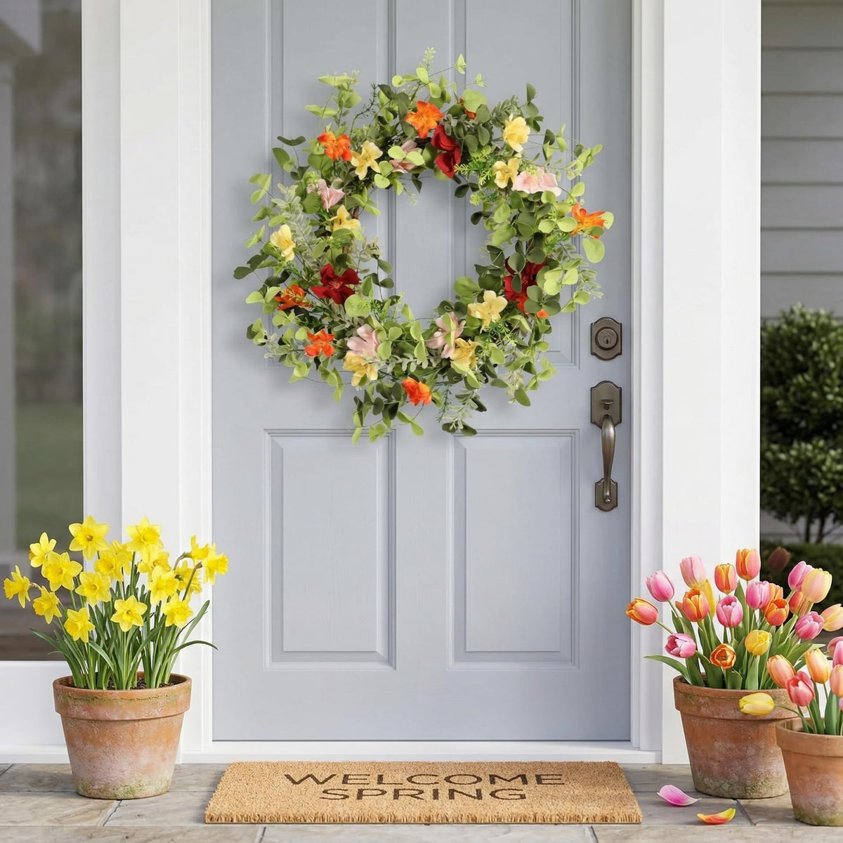 Pudate 22in artificial wreath hanging on interior wall with vivid blossoms.