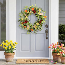 Pudate 22in artificial wreath hanging on interior wall with vivid blossoms.