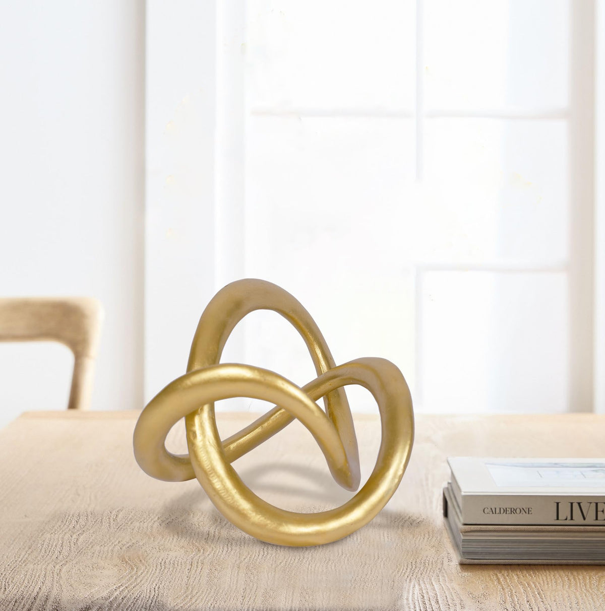 PUHOZN gold knot sculpture on bookshelf enhances decor