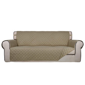 PureFit reversible quilted sofa cover in beige protects against spills and pet fur.