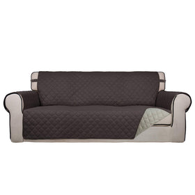 PureFit reversible quilted sofa cover in chocolate and beige protects upholstery from spills and fur.
