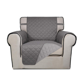 PureFit reversible quilted sofa cover draped on chair for protection