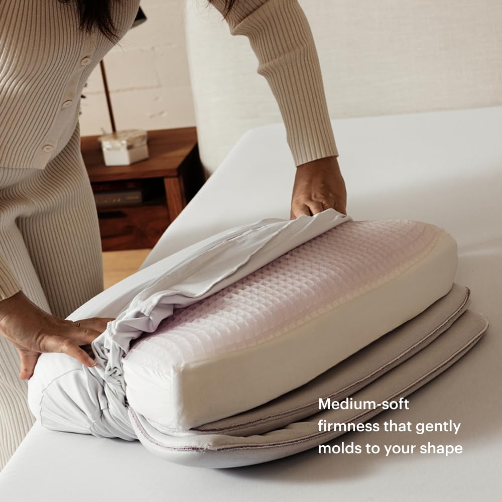 Purple DreamLayer Pillow on bed shows cooling, breathable sleep surface for hot sleepers.