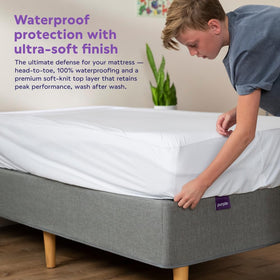 Purple protector stretched on bed demonstrates flexible fit for mattresses of varying height.