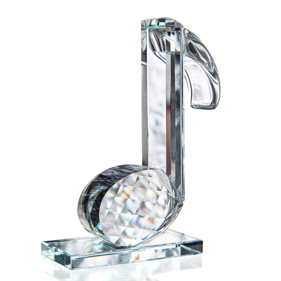 QFkris crystal eighth-note figurine on piano display with subtle sparkle