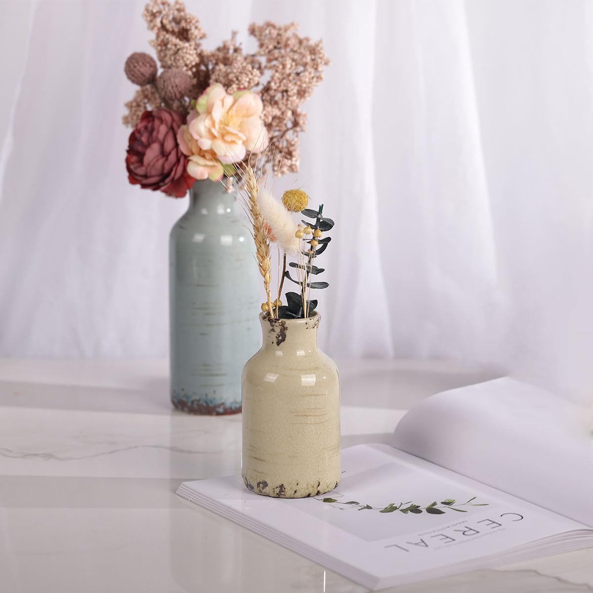 QIANLING ceramic vase with distressed rim detail adds vintage texture.