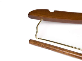 Quality Hangers curved hanger with 360-degree gold swivel hook.