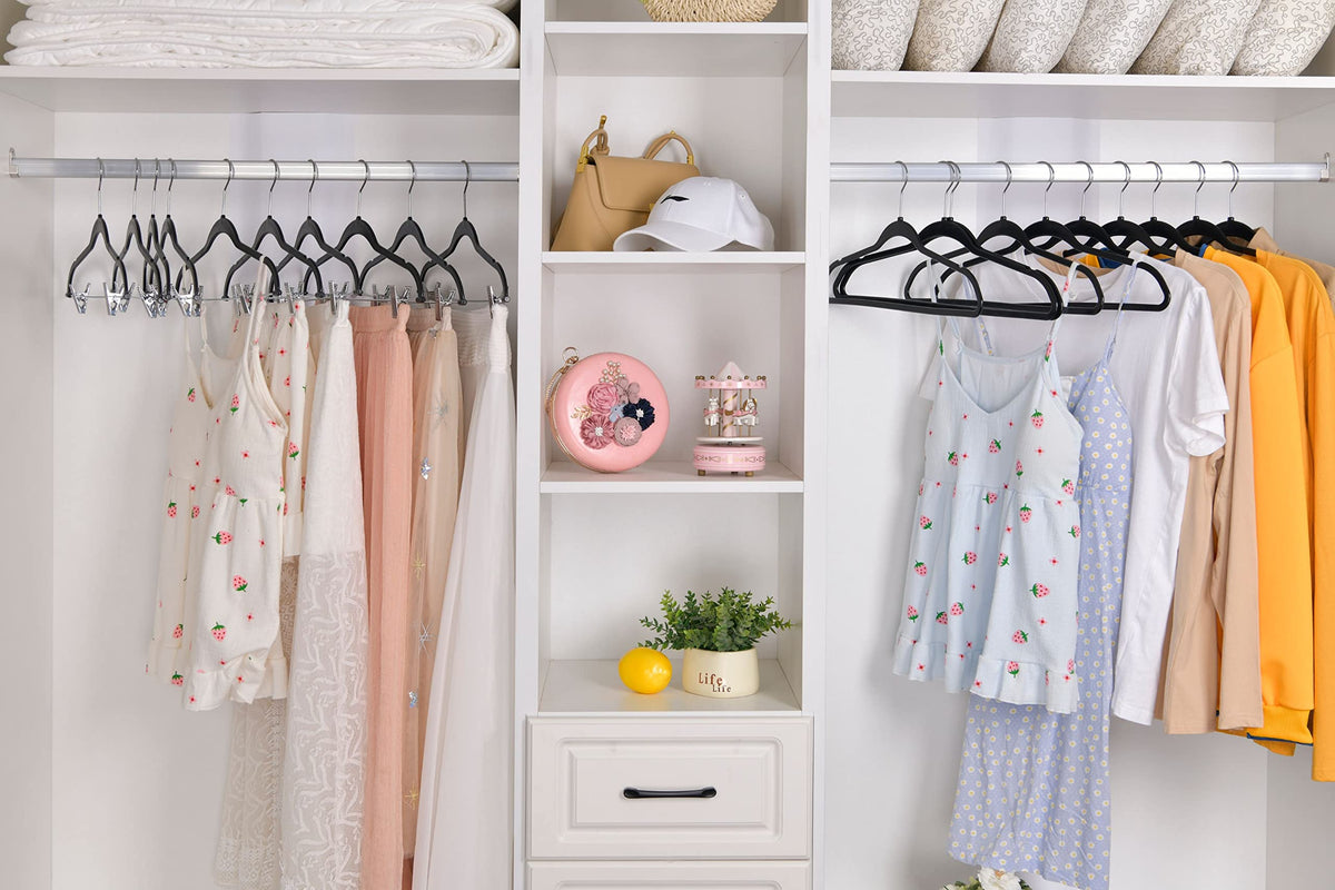 Quality Hangers plastic hangers with non-slip notches secure delicate fabrics in a closet.