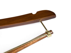 Quality Hangers walnut finish hanger display in a premium closet.