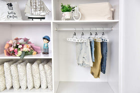 Quality Hangers white skirt hangers enhance bedroom closet organization.