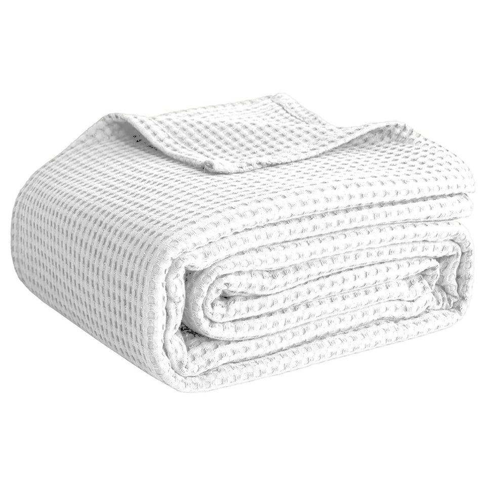 QUBA LINEN waffle blanket on a white king bed showing textured weave and cozy warmth
