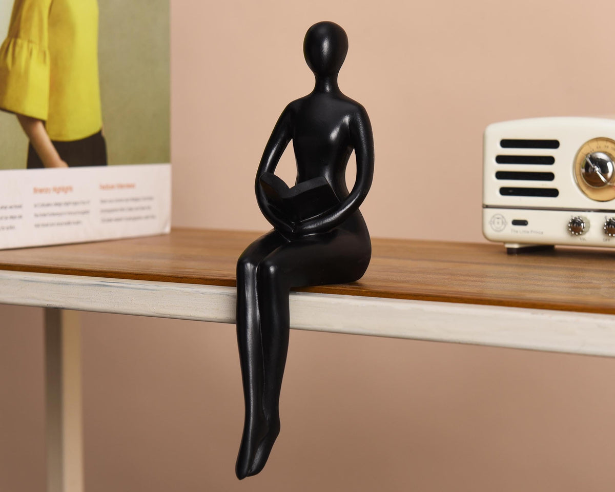 Quoowiit Black Thinker Statue on a coffee table elevates styling.