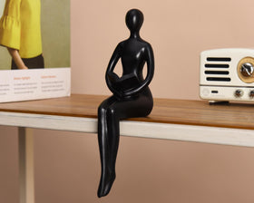 Quoowiit Black Thinker Statue on a coffee table elevates styling.