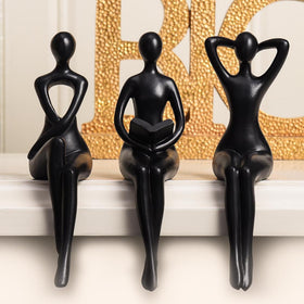 Quoowiit Black Thinker Statue relaxes on a shelf with modern appeal.
