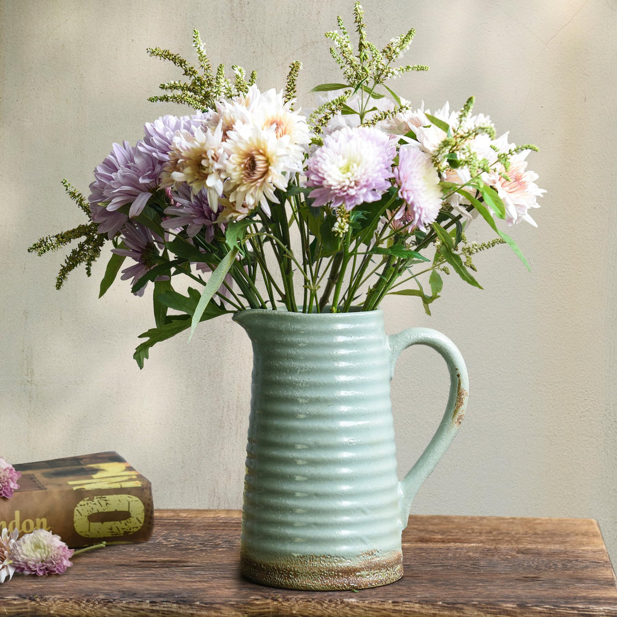 Quoowiit ceramic rustic vase with handle for easy repositioning of florals.
