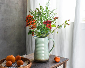 Quoowiit green distressed finish vase highlights vintage charm for living room decor.
