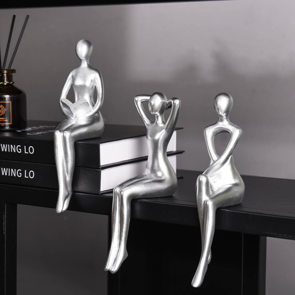 Quoowiit Thinker Statue on a desk showcases modern art and serenity.