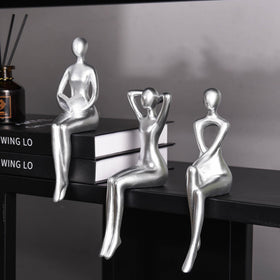 Quoowiit Thinker Statue on a desk showcases modern art and serenity.