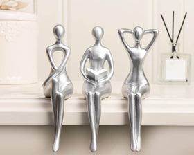 Quoowiit Thinker Statue with silver textured surface adds contemporary shelf appeal.