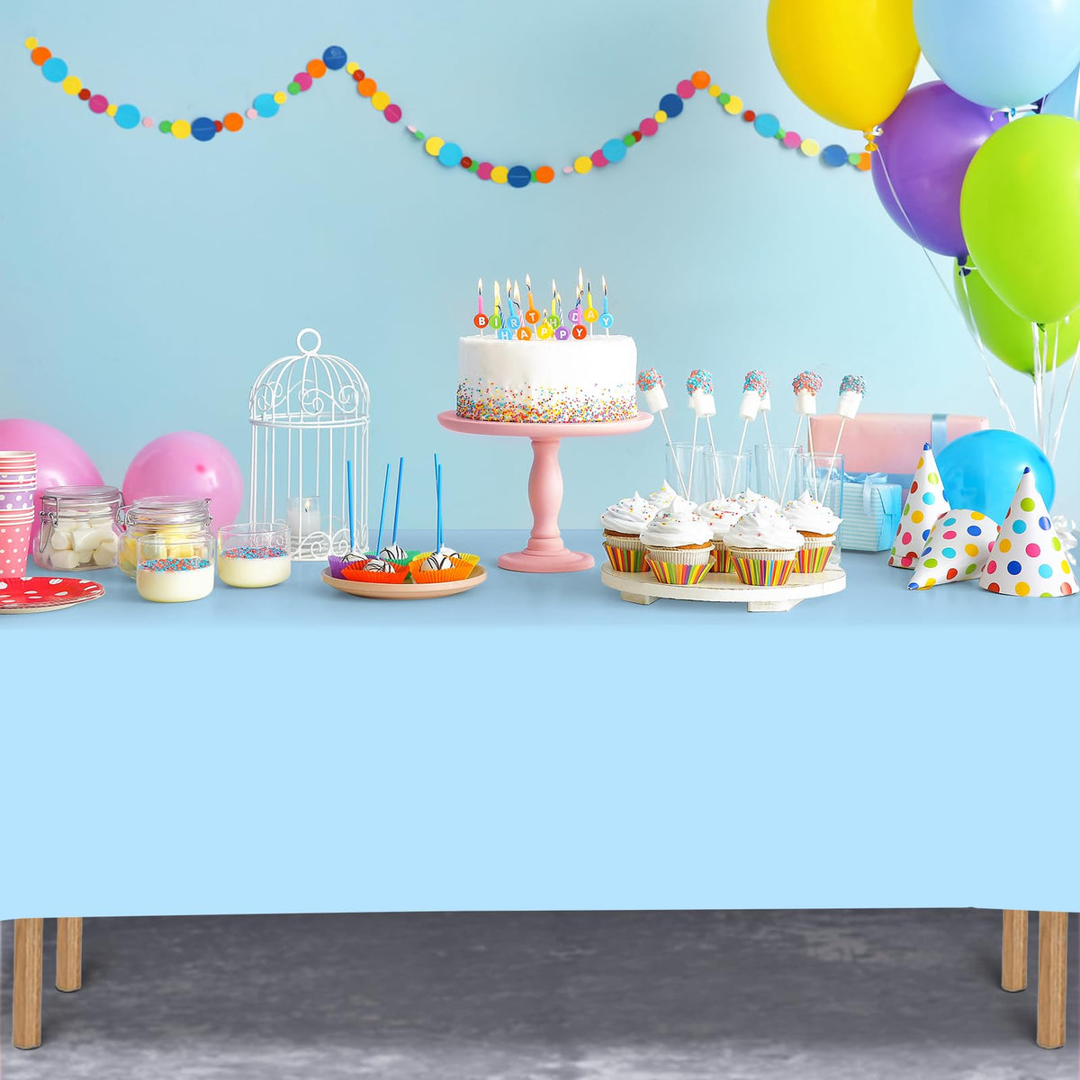 Birthday party setup using Ragnhild light blue 54x108 tablecloths.