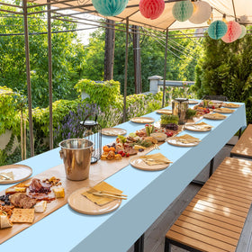 Rectangular dining area covered by Ragnhild light blue disposable tablecloths.