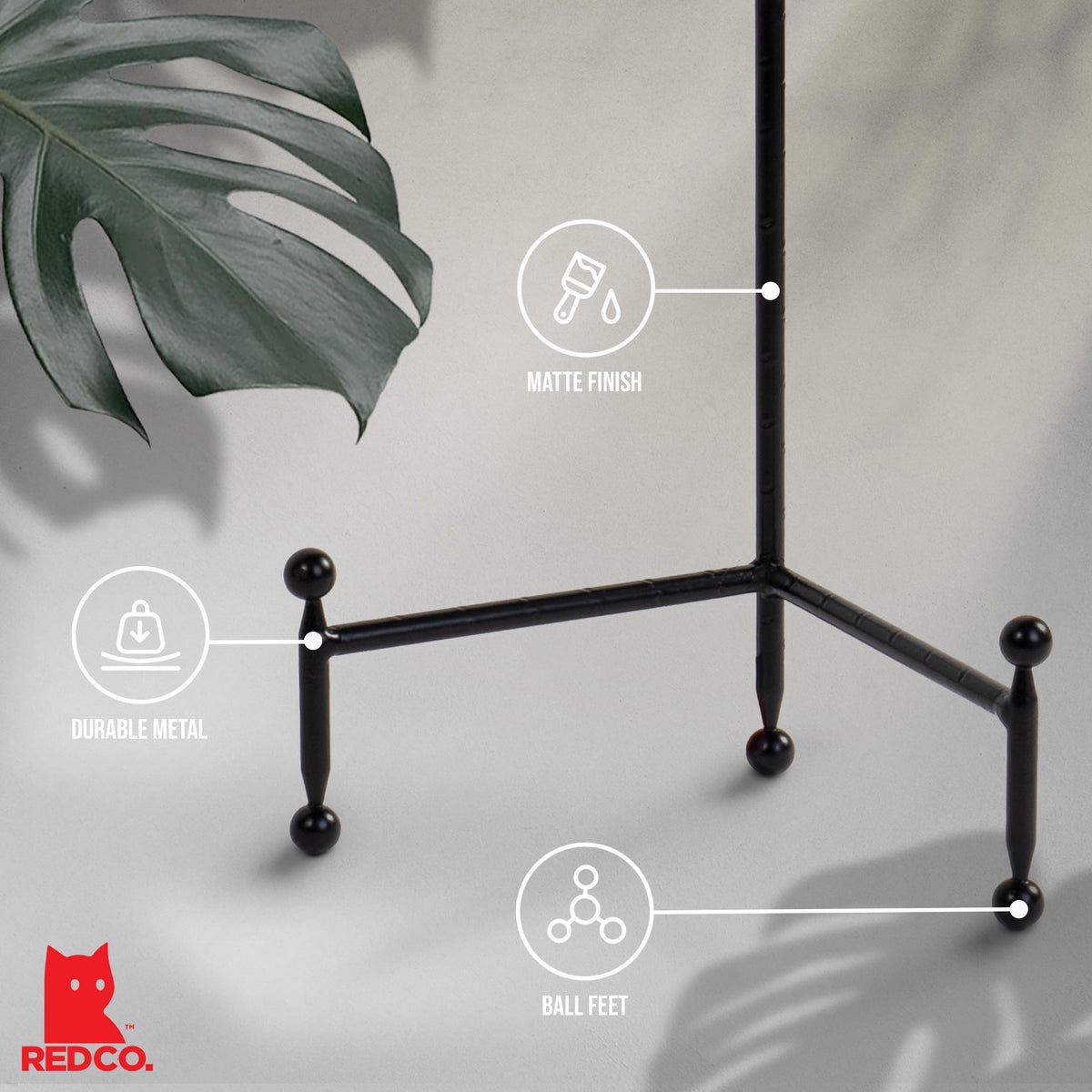 Red Co tabletop display stand in black supports books or collectibles on a counter.