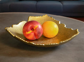 Red Co torn metal bowl serves as a bold coffee table accent