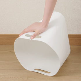 rejomiik slim trash can beside cabinet in a modern kitchen.