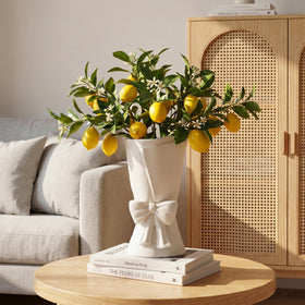 Relexome bow vase close-up, textured matte finish enhances a craft-like centerpiece.
