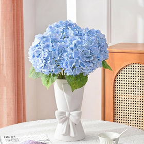 Relexome bow vase on table as a versatile centerpiece.