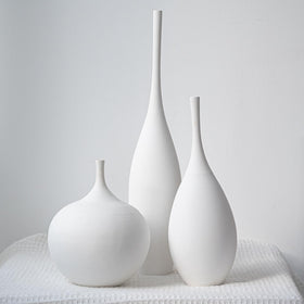 Relexome white ceramic vase trio on desktop adds subtle elegance