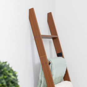 RELODECOR rustic blanket display on a leaning ladder in a living space.