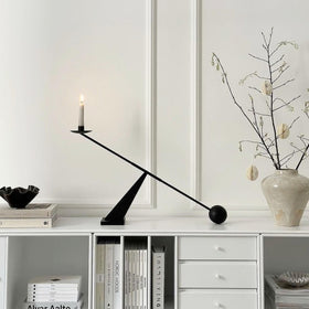 Remenna tapered candle holder design adds geometric elegance to any shelf.