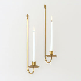 Remenna wall candle holder in wrought iron with gold finish for a durable, elegant touch.