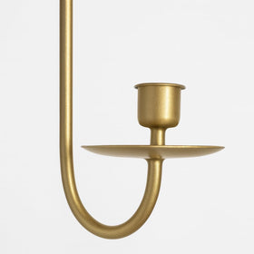 Close-up of the gold finish on a Remenna sconce showing a smooth matte texture.
