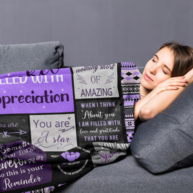 Remwiso blanket demonstrates 60x50 inch size for beds or couches.