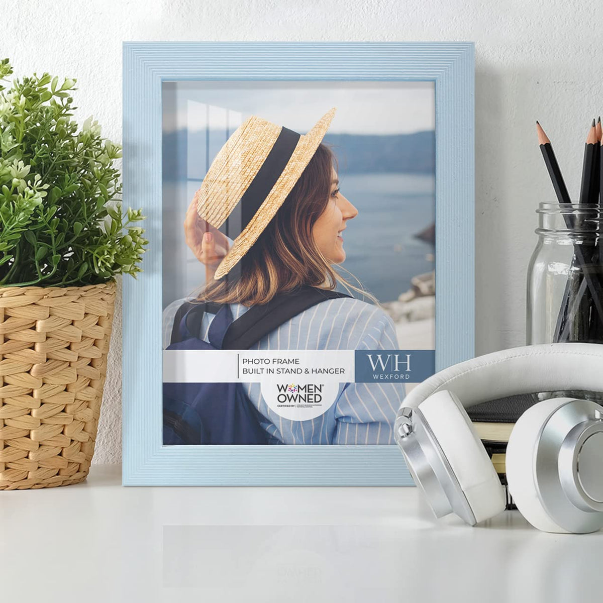 Renditions Gallery blue frame wall-hanging horizontal layout enhances living room decor.