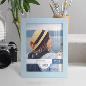 Renditions Gallery blue frame wall-hanging vertical layout enhances hallway decor.
