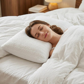 RESTOVIA two-pillow set on bed illustrates versatile side and back comfort.
