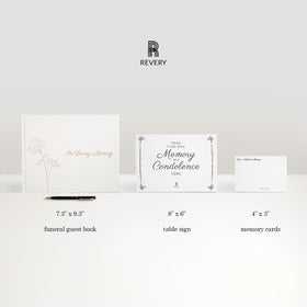 Revery funeral table sign complements a respectful tribute setup.