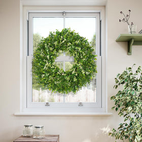 RHTRJ wreath hung on window decorates interior walls with greenery.