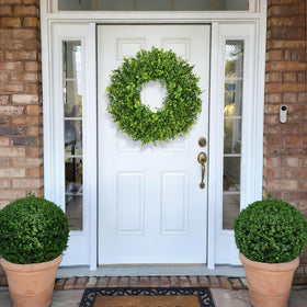 Wreath hung on wall in farmhouse-style setting