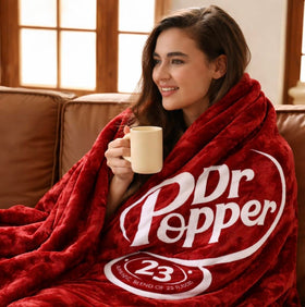 RMKA Dr Pepper blanket on a couch offers warm, movie-night comfort.