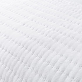 ROARINGWILD stylish bed setup featuring the quilt on a bed