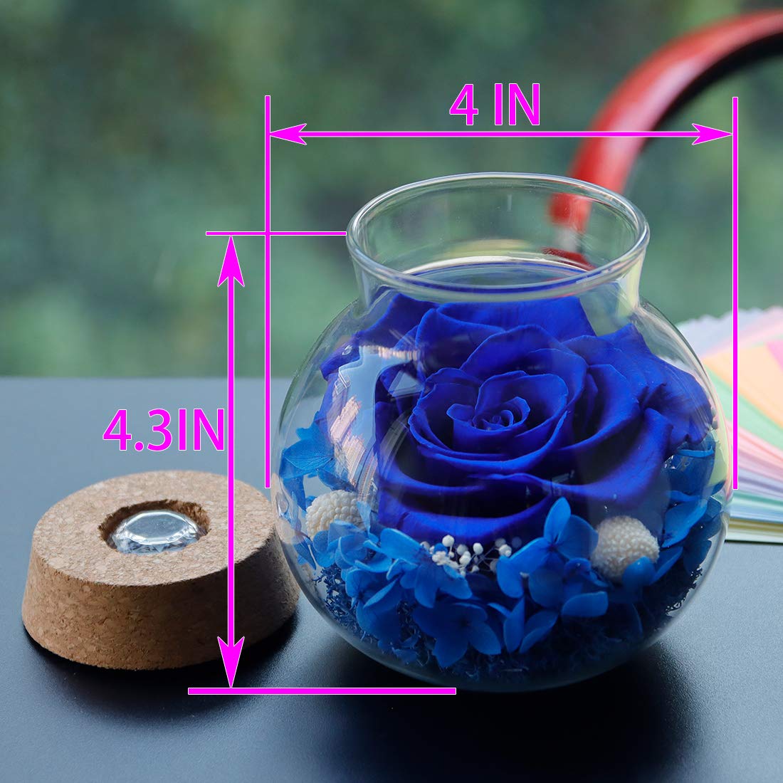 Roliys rose in glass bottle showcases colorful cap lighting for romantic glow.