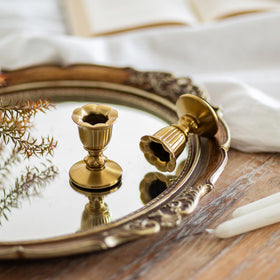 Closeup of Romadedi brass taper candle holders showing Victorian detailing