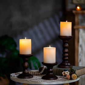 Romadedi wood candlesticks create natural centerpiece on dining table.