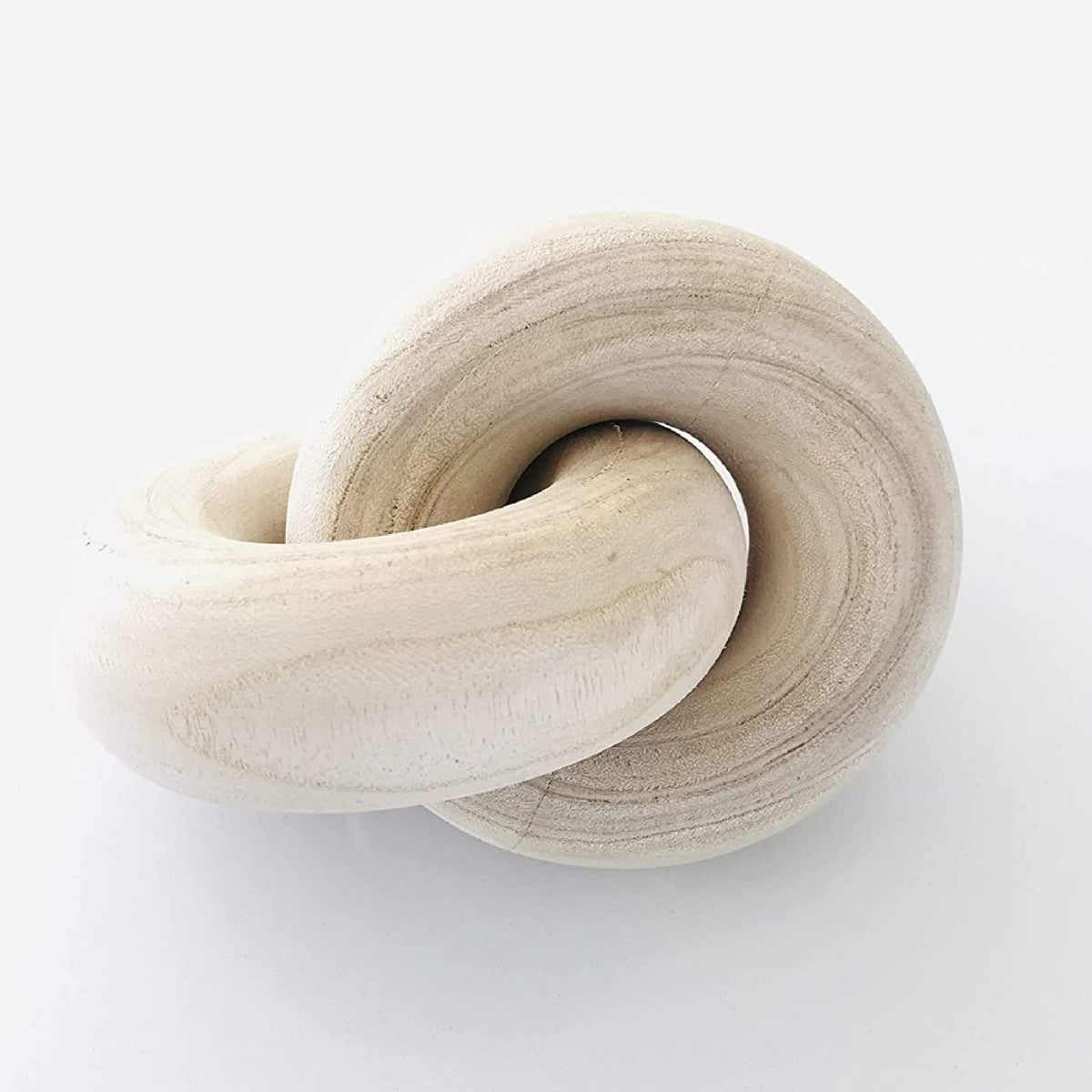 Rool wood knot decor with chain-link design on a beige mantel showing organic texture