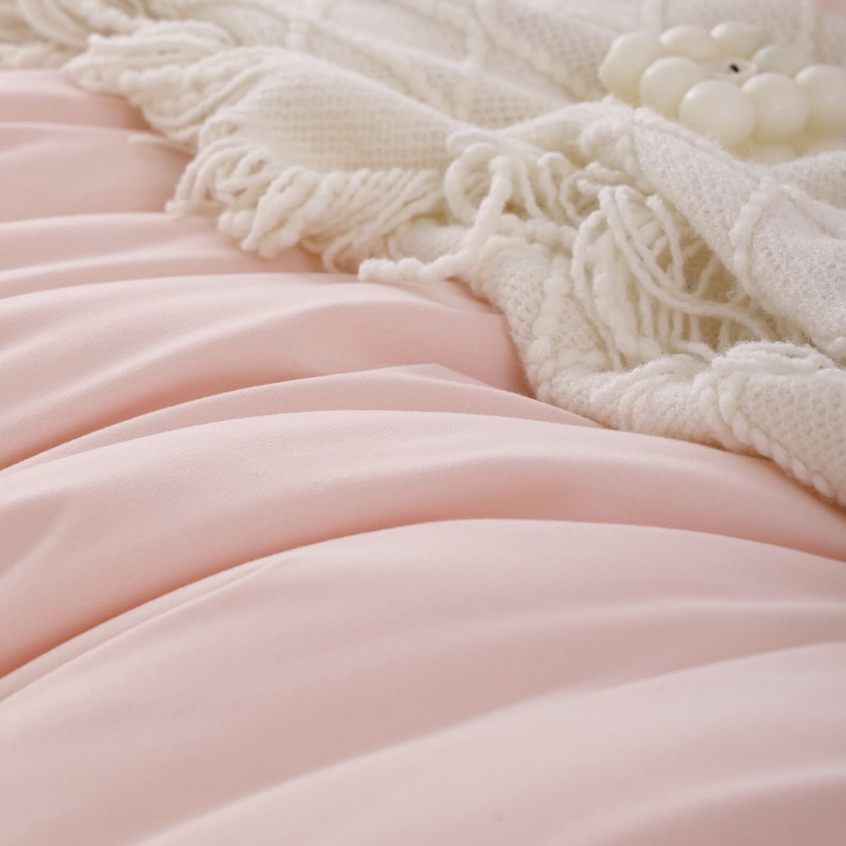 Dorm room styling with ROSGONIA blush comforter and pillows.